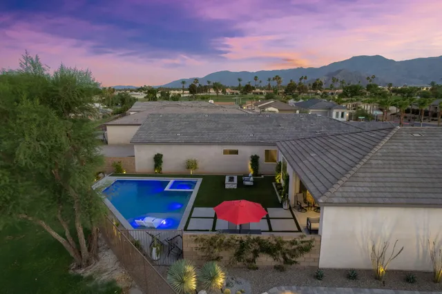 a view of swimming pool with outdoor seating and city view
