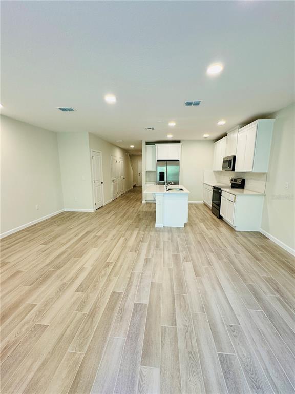 4906 Livingston Lane Oviedo, FL 32765 - Photo 13 of 25 a large room with wooden floor