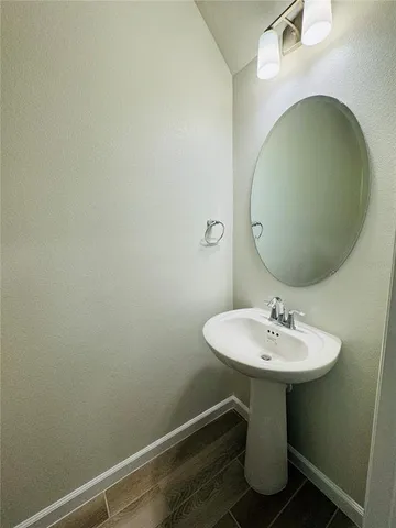 a bathroom with a sink and mirror