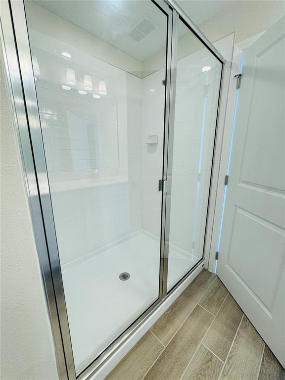 4906 Livingston Lane Oviedo, FL 32765 - Photo 18 of 25 a bathroom with a glass door shower and vanity