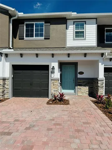 a view of a house with a yard and garage