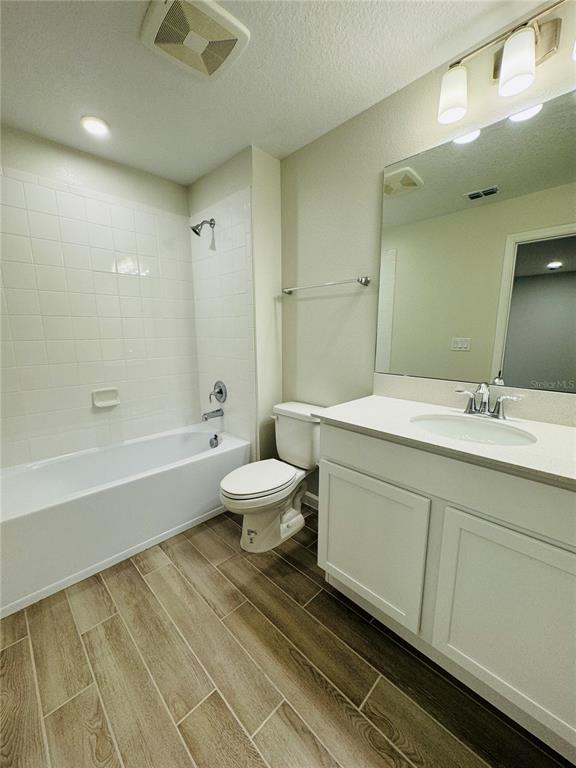 4906 Livingston Lane Oviedo, FL 32765 - Photo 21 of 25 a bathroom with a double vanity sink a toilet and a bathtub