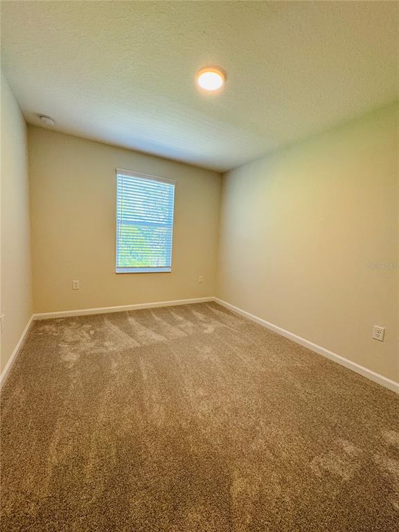 4906 Livingston Lane Oviedo, FL 32765 - Photo 23 of 25 an empty room with a empty space and a window