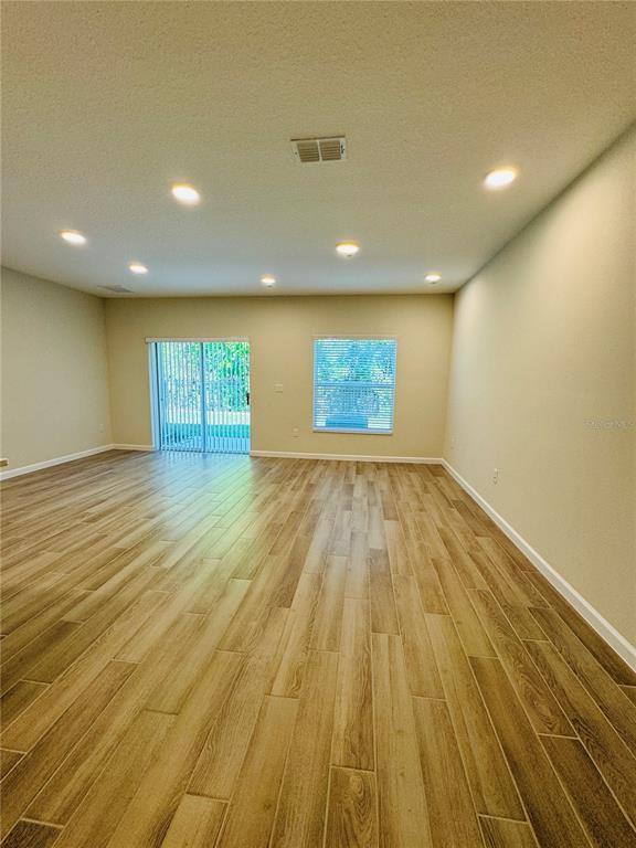 4906 Livingston Lane Oviedo, FL 32765 - Photo 25 of 25 an empty room with wooden floor and windows