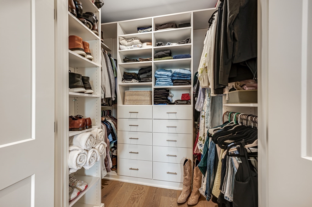 18 Loring Street Boston, MA 02127 - Photo 14 of 27 a view of walk in closet with clothes and shoes