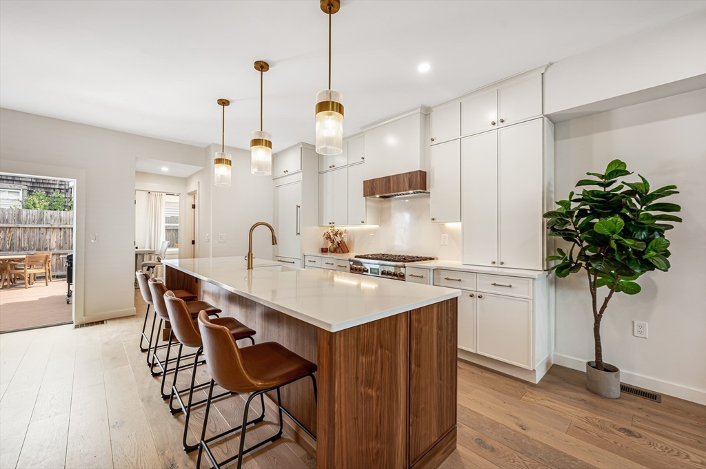 18 Loring Street Boston, MA 02127 - Photo 2 of 27 a kitchen with kitchen island a wooden floor and white appliances