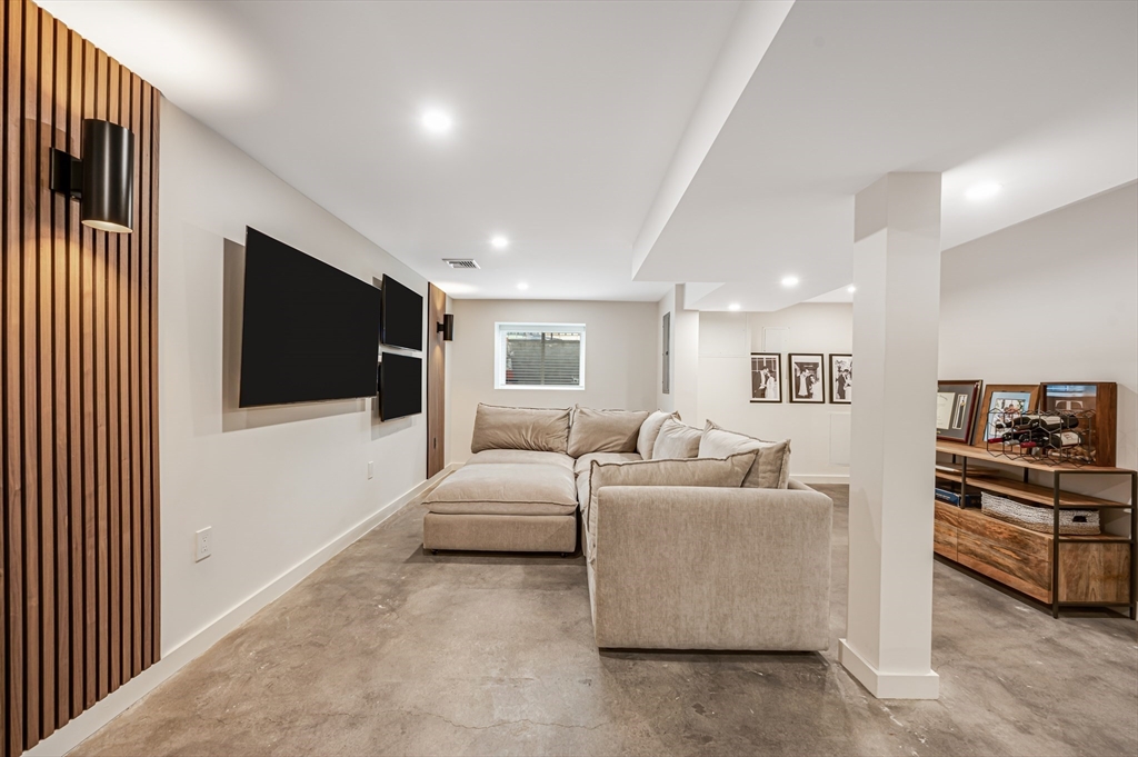 18 Loring Street Boston, MA 02127 - Photo 22 of 27 a living room with furniture and a flat screen tv
