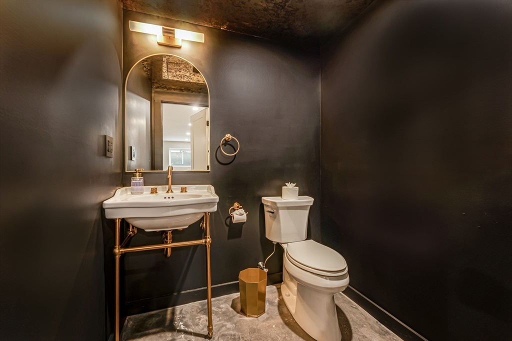 18 Loring Street Boston, MA 02127 - Photo 24 of 27 a bathroom with a toilet sink and mirror