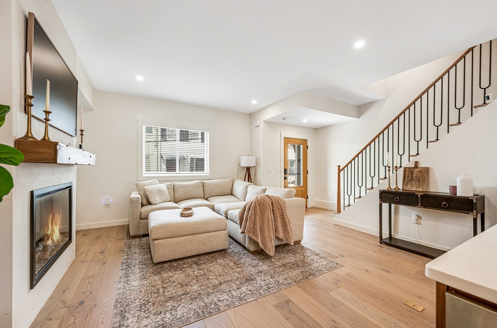 18 Loring Street Boston, MA 02127 - Photo 5 of 27 a living room with furniture and a fireplace with wooden floor