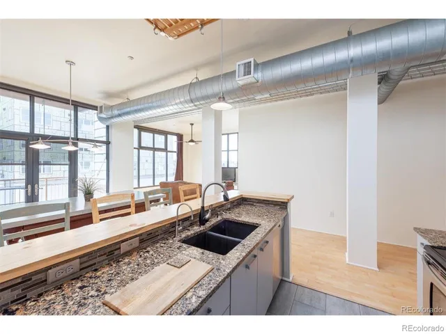 a kitchen with a stove a refrigerator and windows