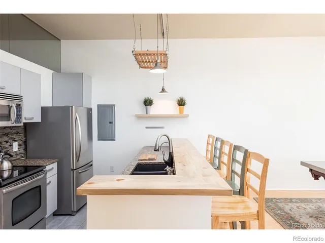 a kitchen with a refrigerator and a sink