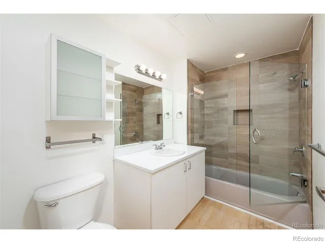 a bathroom with a shower a sink a mirror and a shower