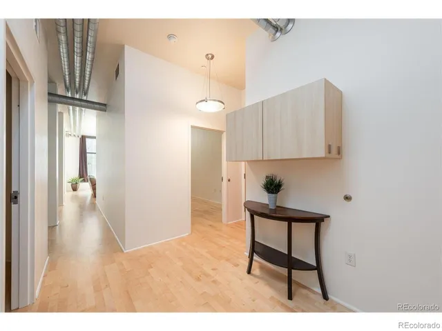 a kitchen with stainless steel appliances kitchen island hardwood floor and a sink