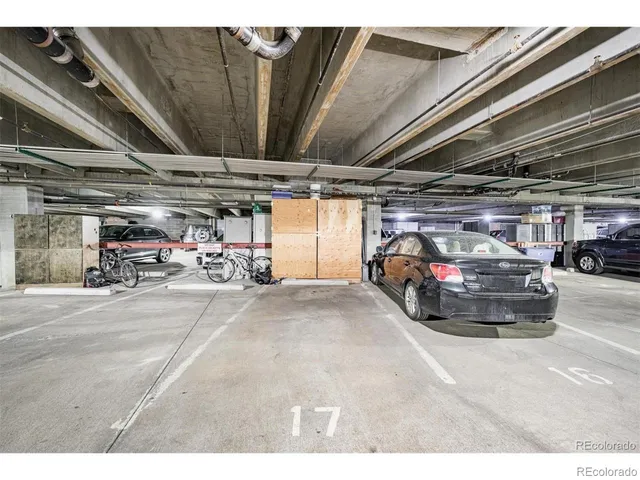 a view of parking garage with cars