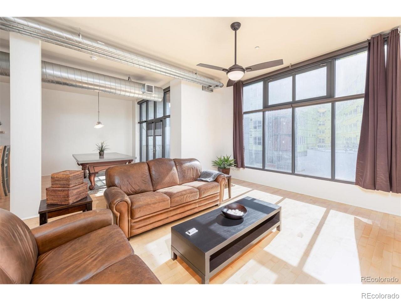 3100 Huron Street, Unit 3P Denver, CO 80202 - Photo 6 of 34 a living room with furniture and a large window