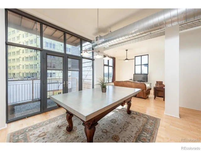a living room with table and a large window