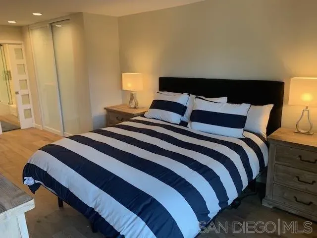 a bedroom with a bed and a night stand