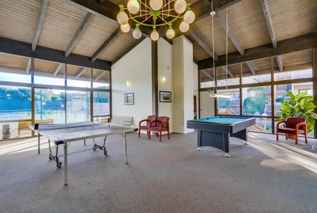 a living room with furniture a window and a chandelier