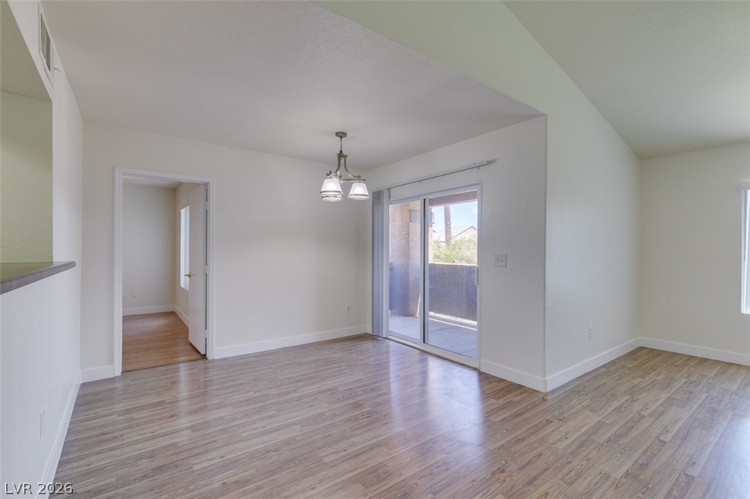 6650 West Warm Springs Road, Unit 2118 Las Vegas, NV 89118 - Photo 7 of 41 A well-lit interior space with sleek hardwood flooring and convenient sliding glass door access to the outdoors.