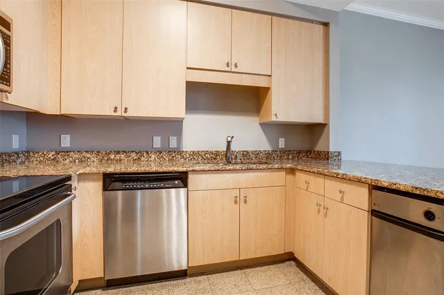 a kitchen with granite countertop white cabinets and white appliances