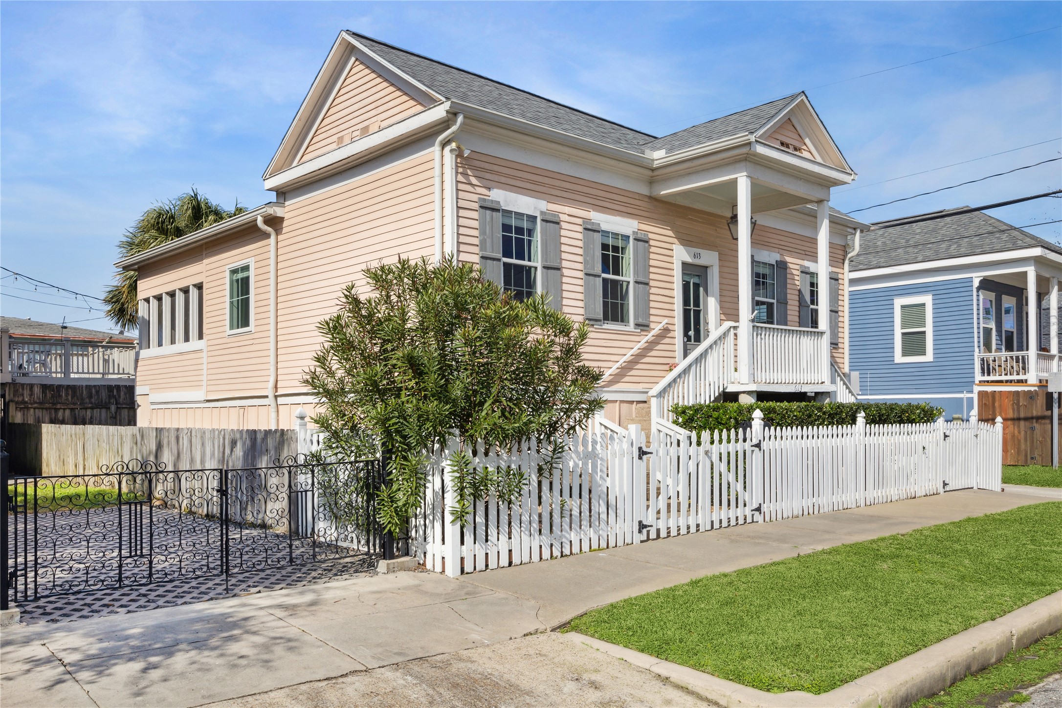 613 9th Street Galveston, TX 77550 - Photo 1 of 35 a front view of a house with a garden and plants