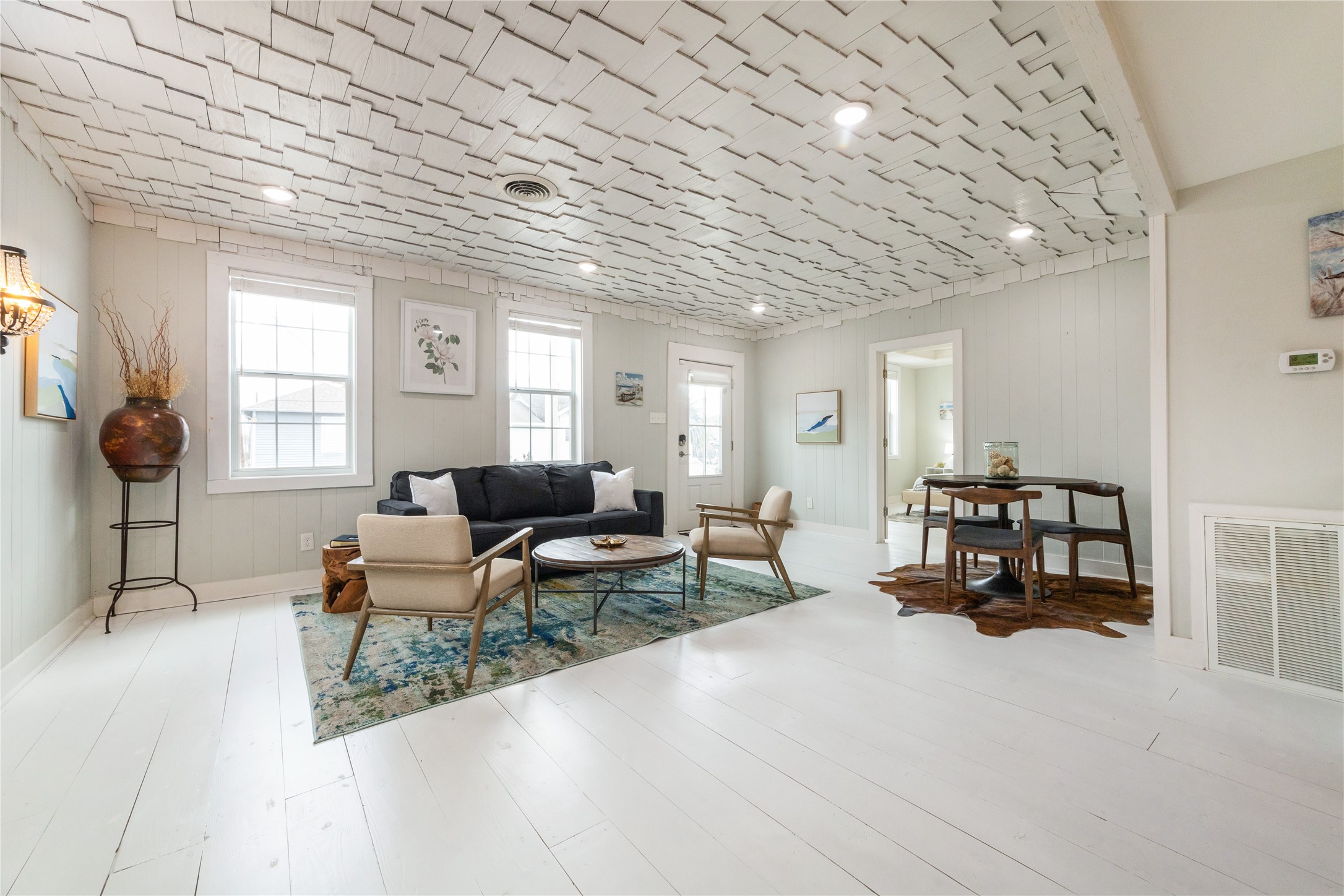 613 9th Street Galveston, TX 77550 - Photo 5 of 35 a living room with furniture and a chandelier