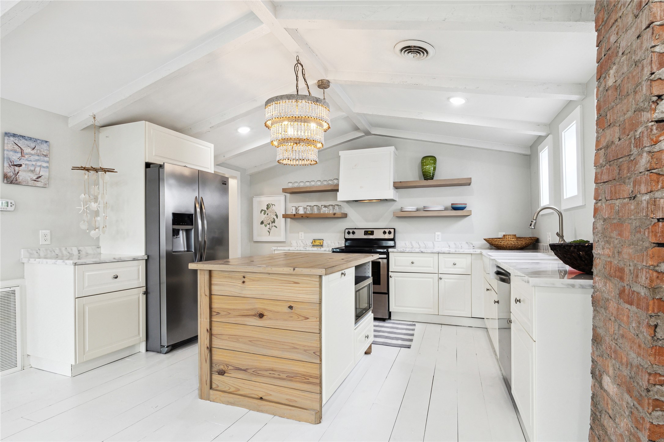 613 9th Street Galveston, TX 77550 - Photo 8 of 35 a kitchen with stainless steel appliances a stove cabinets and refrigerator