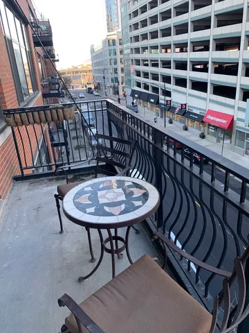 a balcony with table and chairs