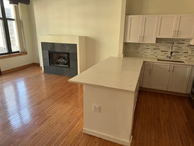 a kitchen with a sink a stove and cabinets