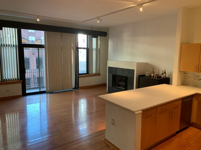 a open kitchen with a sink and a fireplace