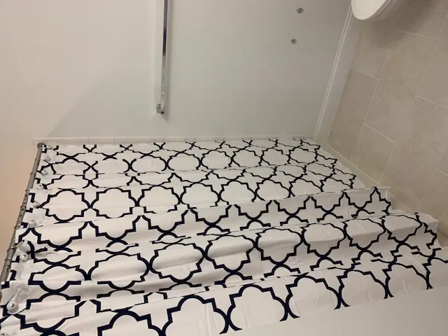 a bathroom with a window and a shower