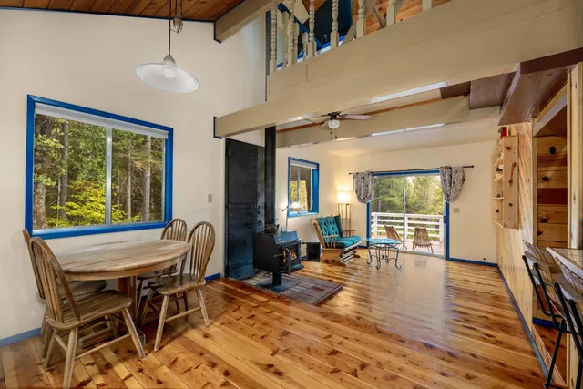 a view of a livingroom with furniture a fireplace and wooden floor