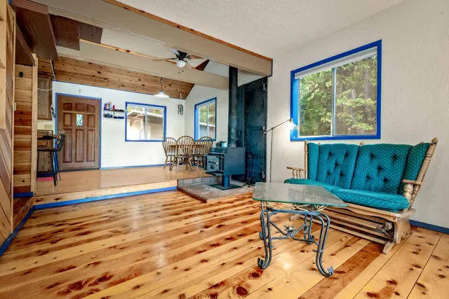 a kitchen with stainless steel appliances granite countertop a sink and cabinets with wooden floor