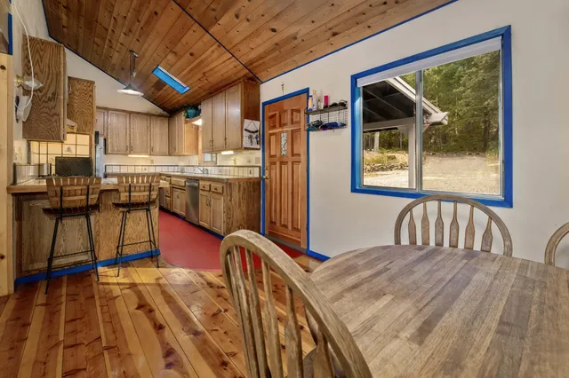 a kitchen with granite countertop white cabinets and stainless steel appliances