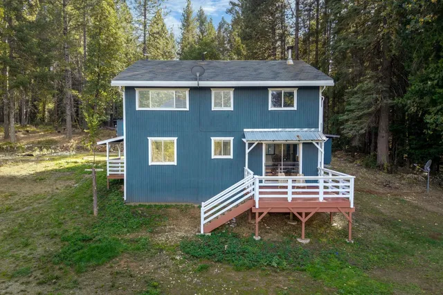 a front view of a house with a yard table and chairs