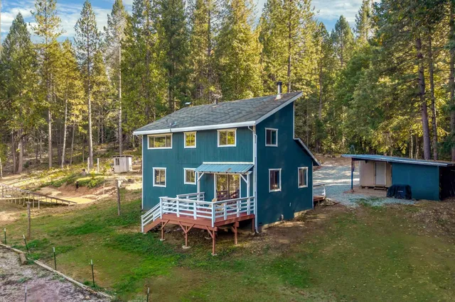 a view of a house with a yard and sitting area