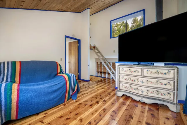 a bedroom with a bed and a flat tv screen