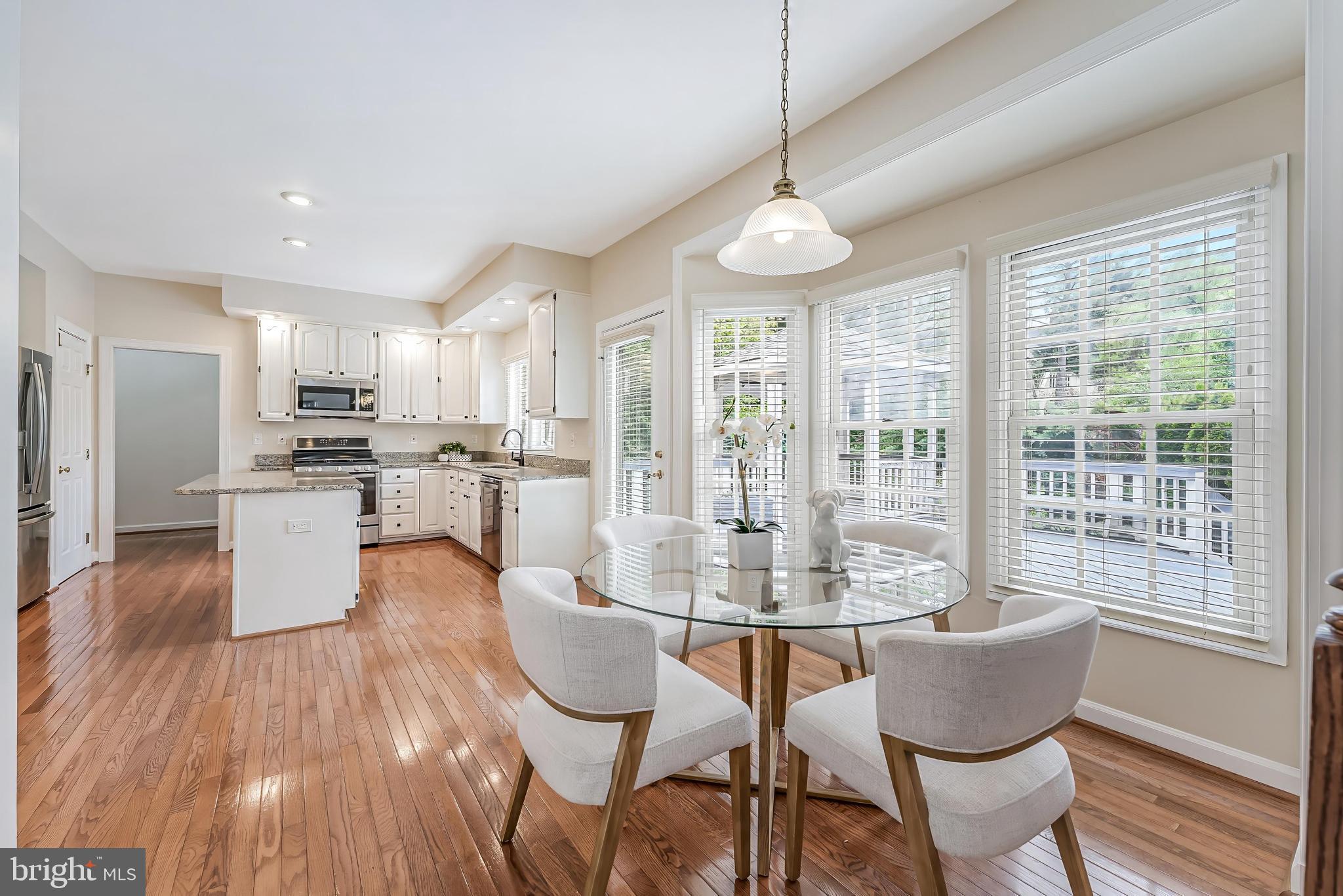 5501 Ashleigh Road Fairfax, VA 22030 - Photo 28 of 77 a dining room with furniture a chandelier and wooden floor