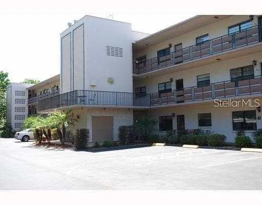 a front view of a building with a garden