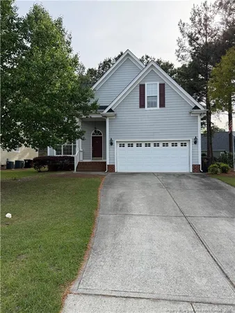 a view of a house with a yard and many windows