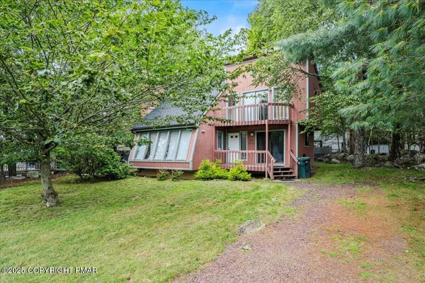 a view of a house with a yard porch and sitting area