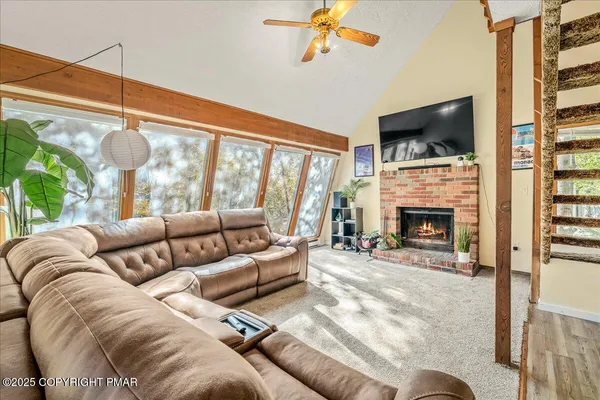 a living room with furniture fireplace and flat screen tv