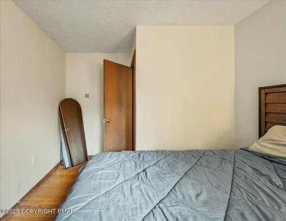 a bedroom with a bed and a night stand