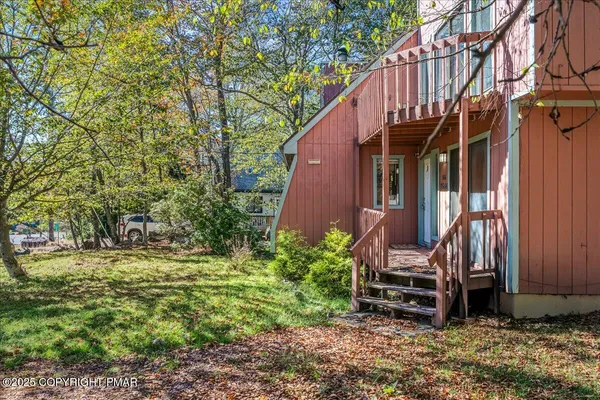 a view of a house with a yard and fence