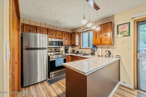 a kitchen with a refrigerator a stove a sink and a microwave