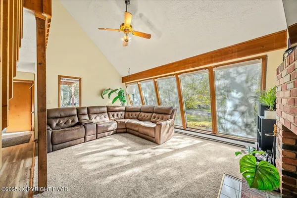 a living room with furniture and a floor to ceiling window