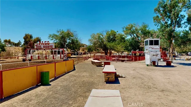 a view of a swimming pool with outdoor seating and a garden