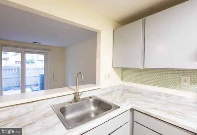 a kitchen with a sink and a window