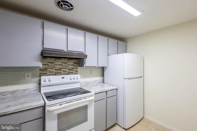 a kitchen with a stove and a refrigerator