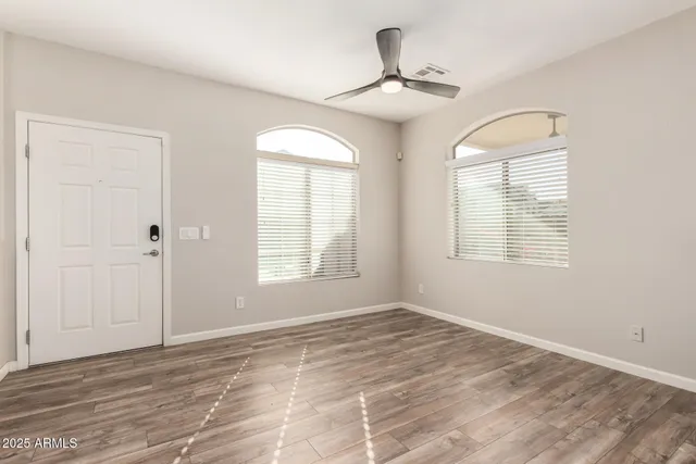 wooden floor in an empty room with a window